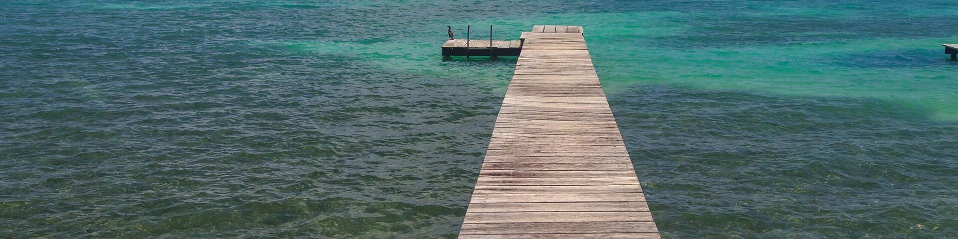 Seascape and wooden pier, St. Georges Caye, Belize, Central America