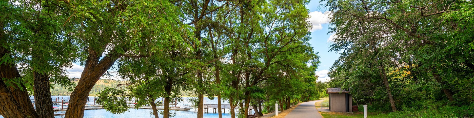 The Trail of the Coeur d'Alenes as it runs past a small sandy beach at the small lakeside town of Harrison, Idaho, USA, in the general Coeur d'Alene area of North Idaho.