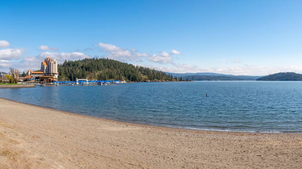 Panoramic view from the beach shoreline of Lake Coeur d'Alene with the downtown resort area in view in the mountain town of Coeur d'Alene, Idaho USA.