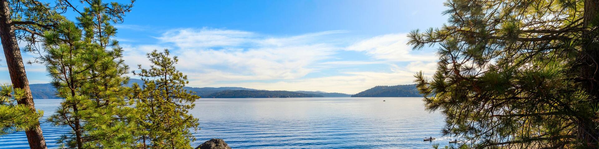 View from the rocky coastline of Tubbs Hill park along the lake in the downtown district of Coeur d'Alene, Idaho, USA.