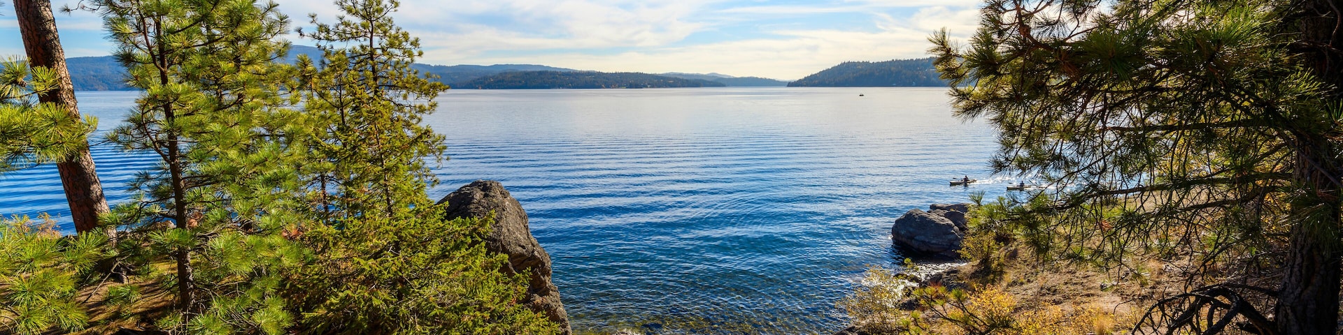 View from the rocky coastline of Tubbs Hill park along the lake in the downtown district of Coeur d'Alene, Idaho, USA.