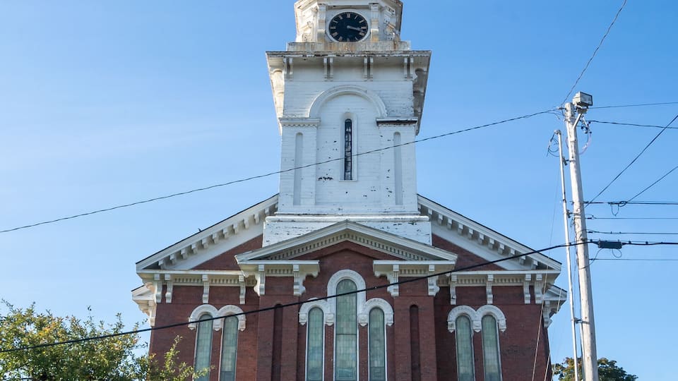 Bangor, ME - USA - Oct. 12, 2021: Vertical head on view of The Union Street Brick Church, a landmark church located in the heart of the downtown historic district at 126 Union St. in Bangor, Maine