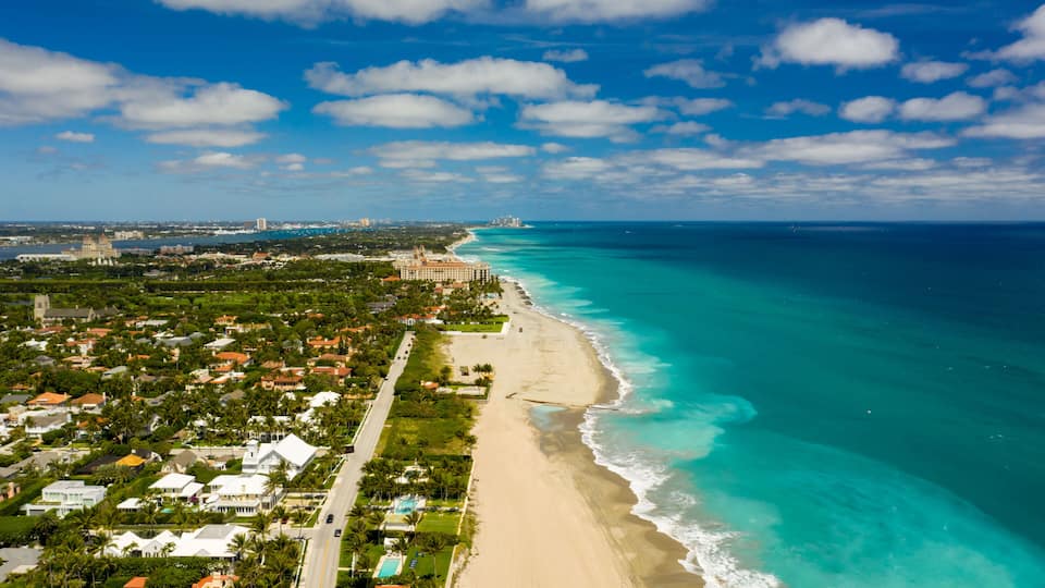 A coastal town with a beach, ocean, and residential area.