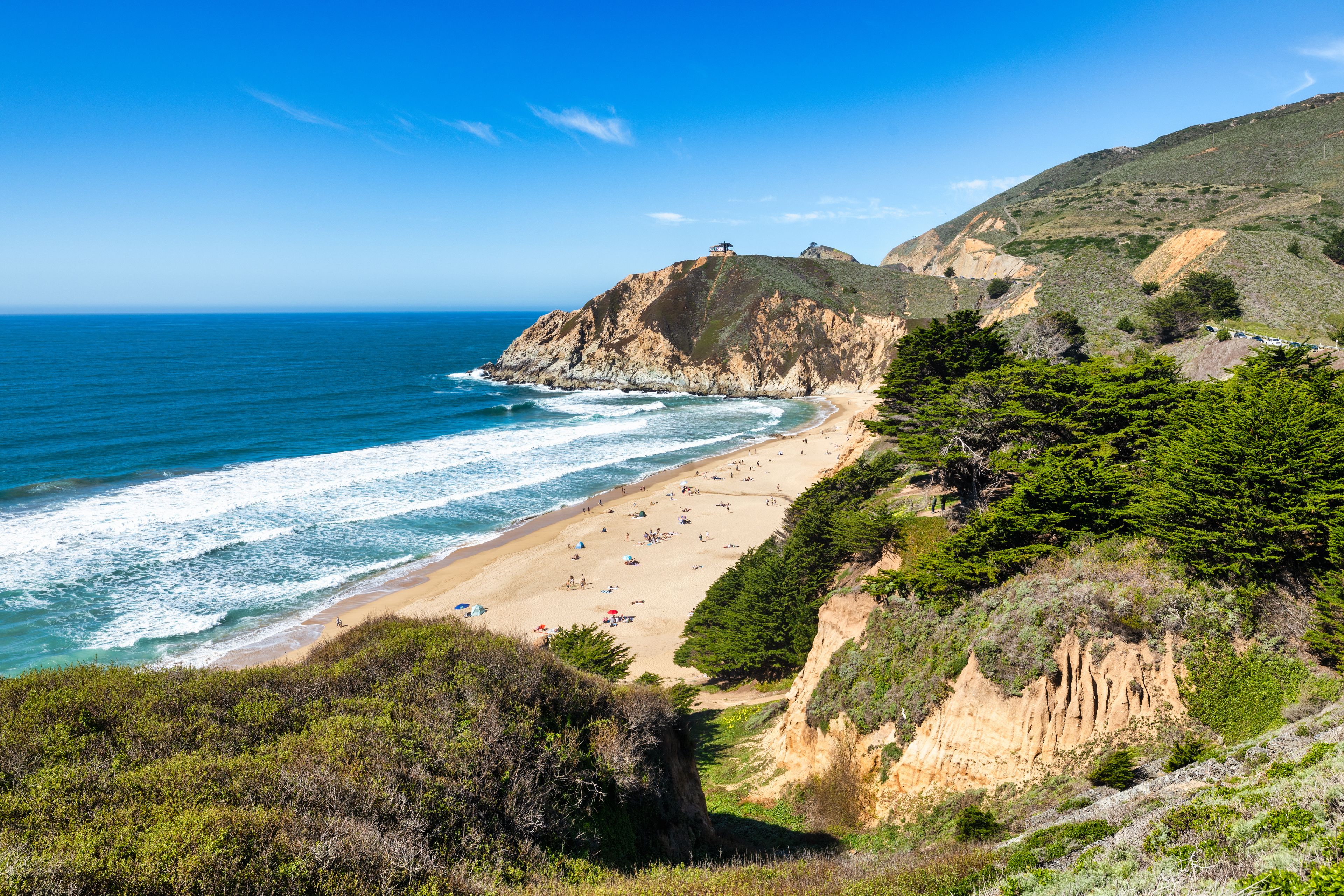 Devils Slide Beach near Pacifica, California, scenic coastal view with sandy beach, ocean waves and rugged cliffs along Highway 1, sunny Bay Area shoreline landscape
