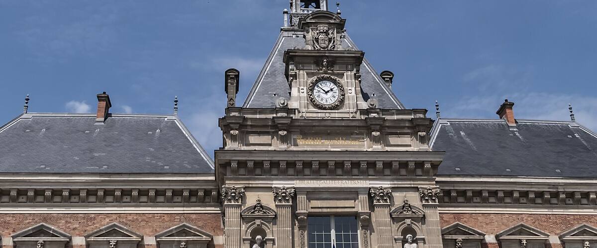 Architectural fragments of XIX arrondissement City hall (inscription: Mairie du XIX Arr, 1878) in Paris. XIX arrondissement called Butte-Chaumont, situated on right bank of River Seine. Paris, France.