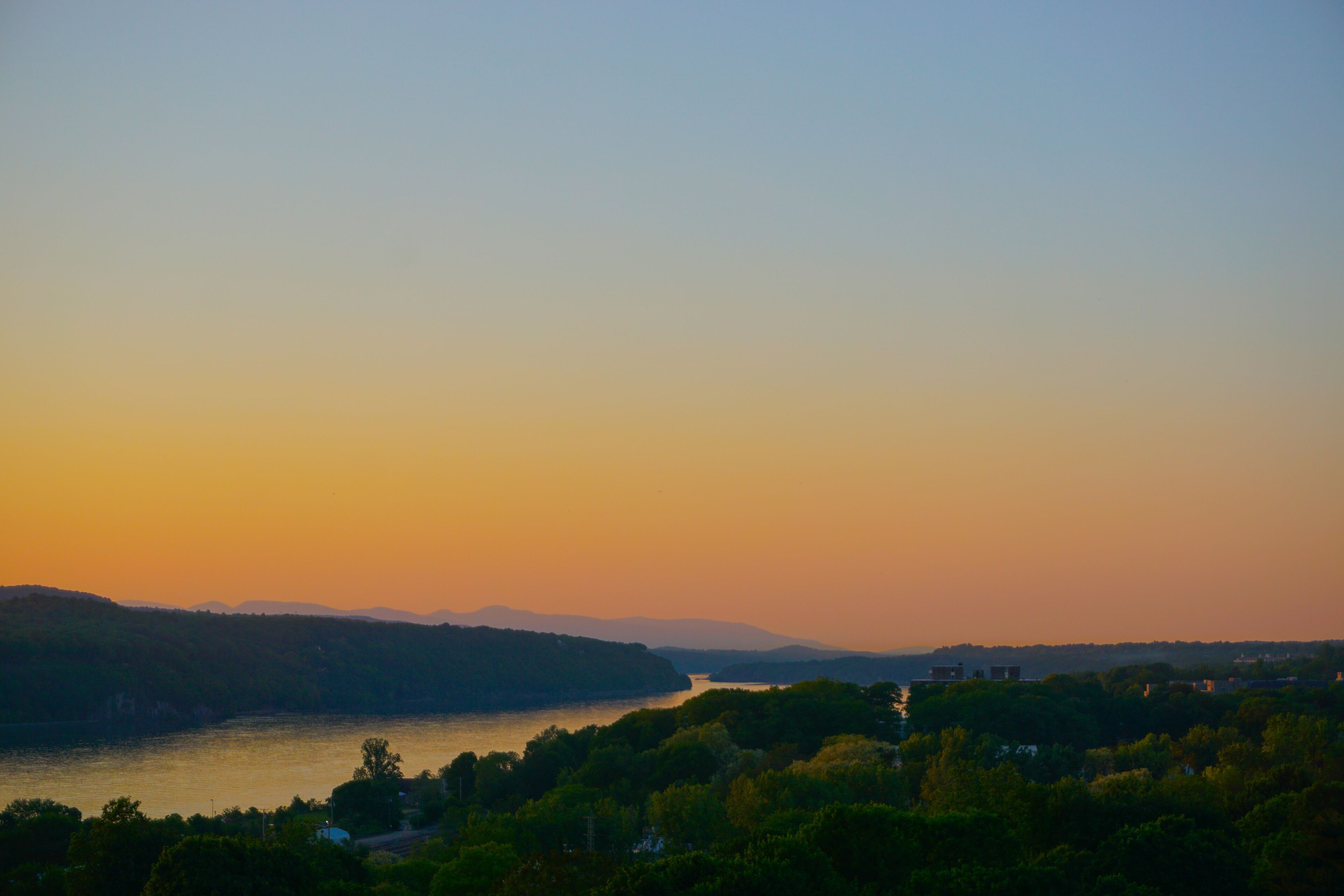Poughkeepsie, New York: View of sunset over the Hudson River, with the Catskill Mountains in the background, from the Walkway Over the Hudson.