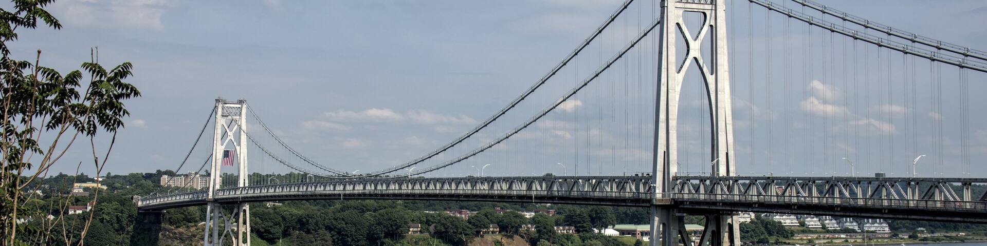 view of the mid hudson bridge to poughkeepsie, new york from highland (suspension bridge over river crossing) scenic landmark (pedestian and bike path, car lanes highway) valley ny state detail