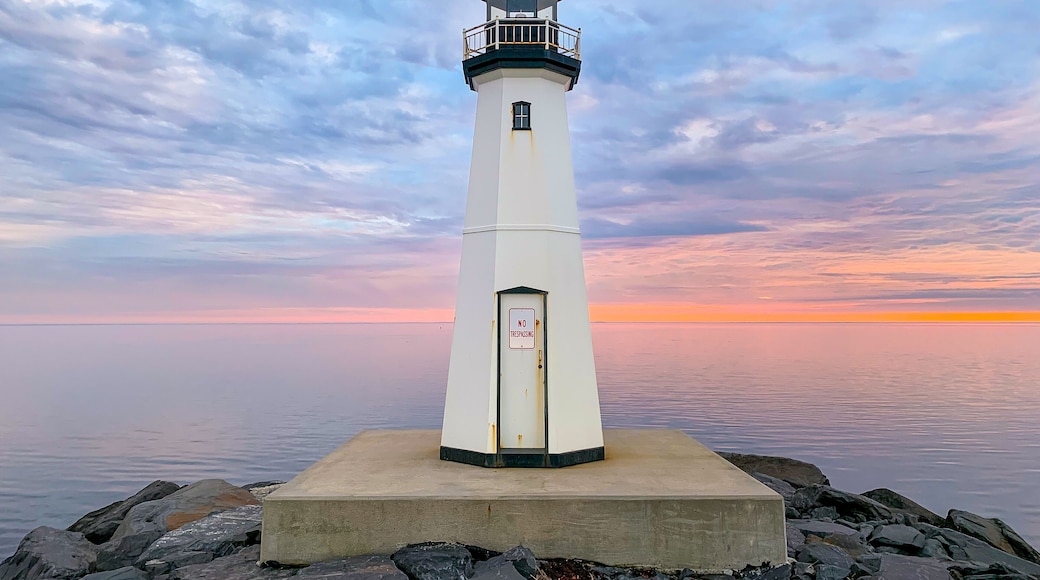 Sandspit Park Lighthouse and fishing pier in Patchogue New York, Long Island, with colorful sunset clouds and colors