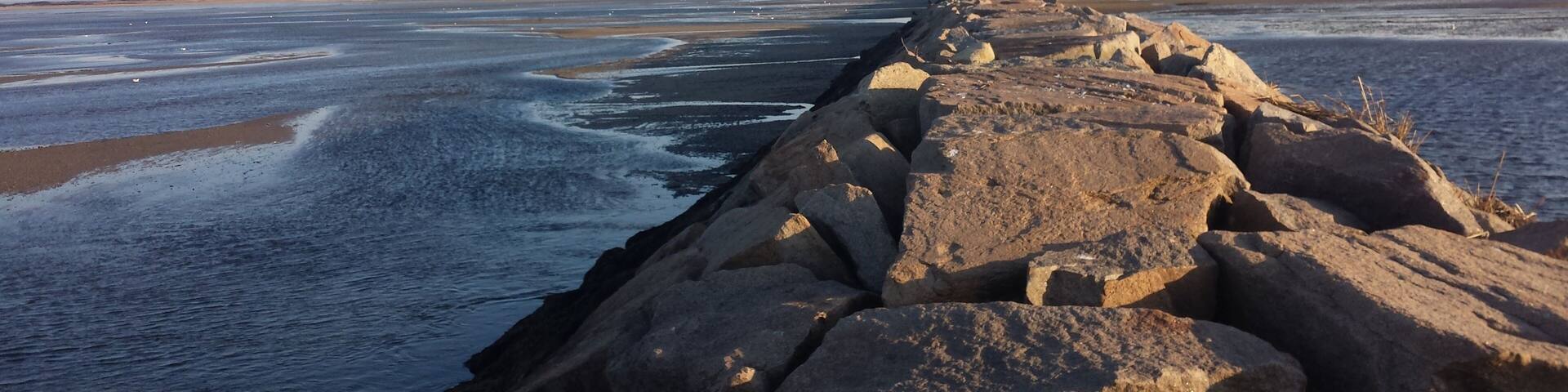 A rocky shoreline with waves crashing against the rocks.
