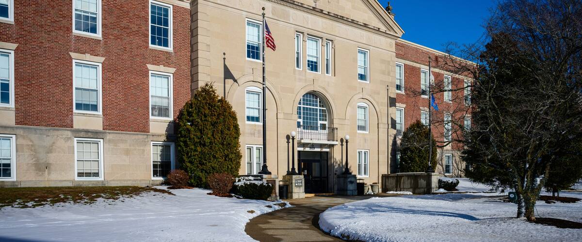Cranston City Hall landmark building with curved pedestrian entrance with snow on the lawn in the suburb of Providence, Rhode Island, USA