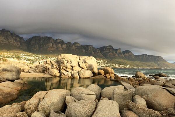 This tidal pool at the north end of Camps Bay main beach is the perfect spot to watch the sun sink while the "Table Cloth" rolls over Table Mountain National Park #GoldenHour #CampsBay #SouthAfrica #CapeTown