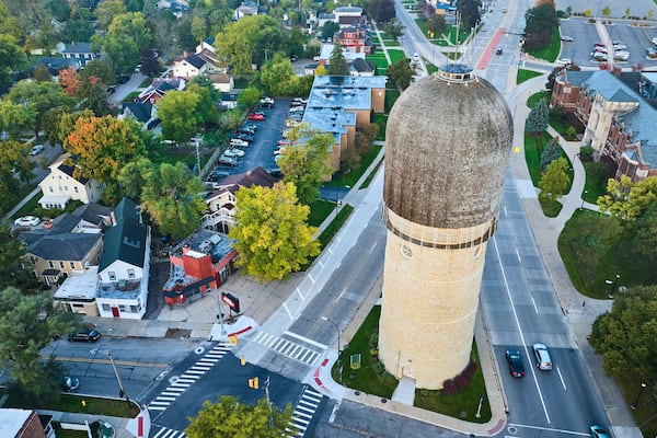 Aerial Suburban Evening with Water Tower and Autumn Trees