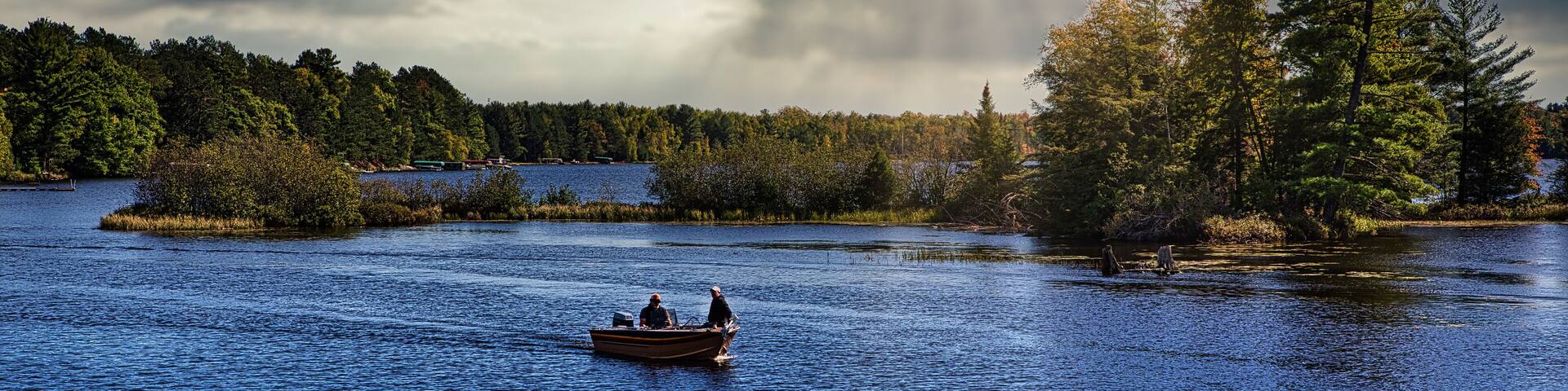 Fishermen in fishing boat on lake in Michigan