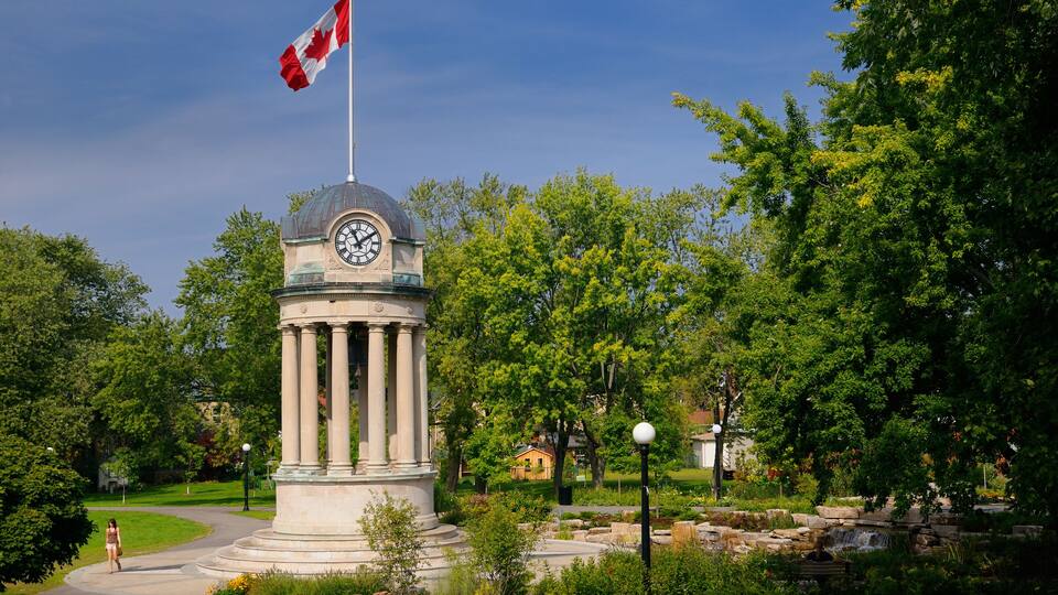 Old City Hall Clock Tower and fountain in Victoria Park Kitchener with Canadian flag