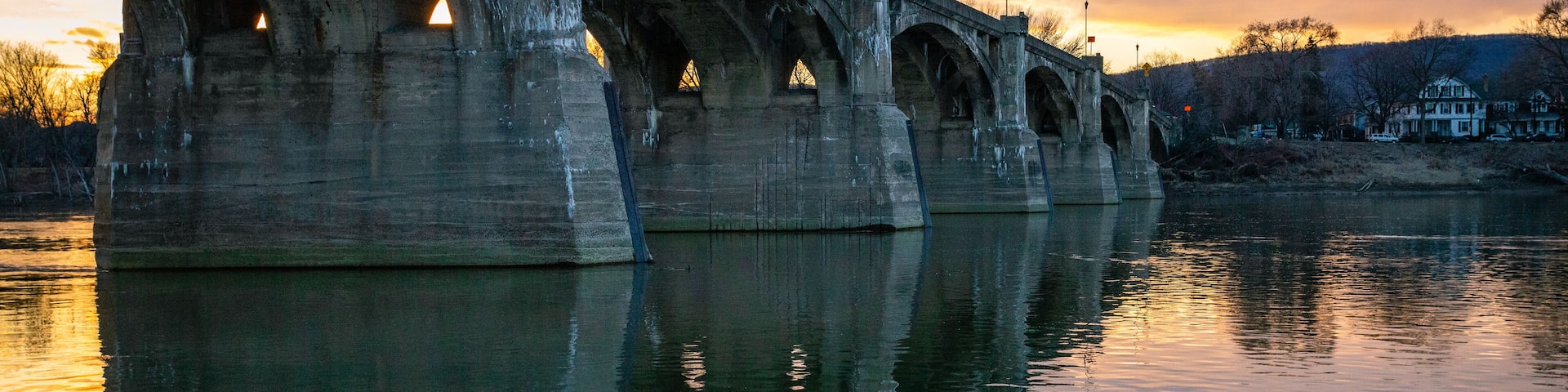 A beautiful sunset behind a bridge over a river in Pittston, PA