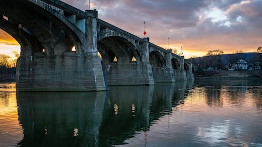 A beautiful sunset behind a bridge over a river in Pittston, PA