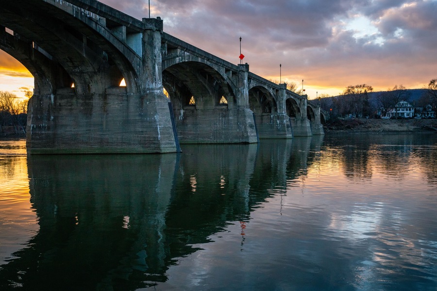 A beautiful sunset behind a bridge over a river in Pittston, PA