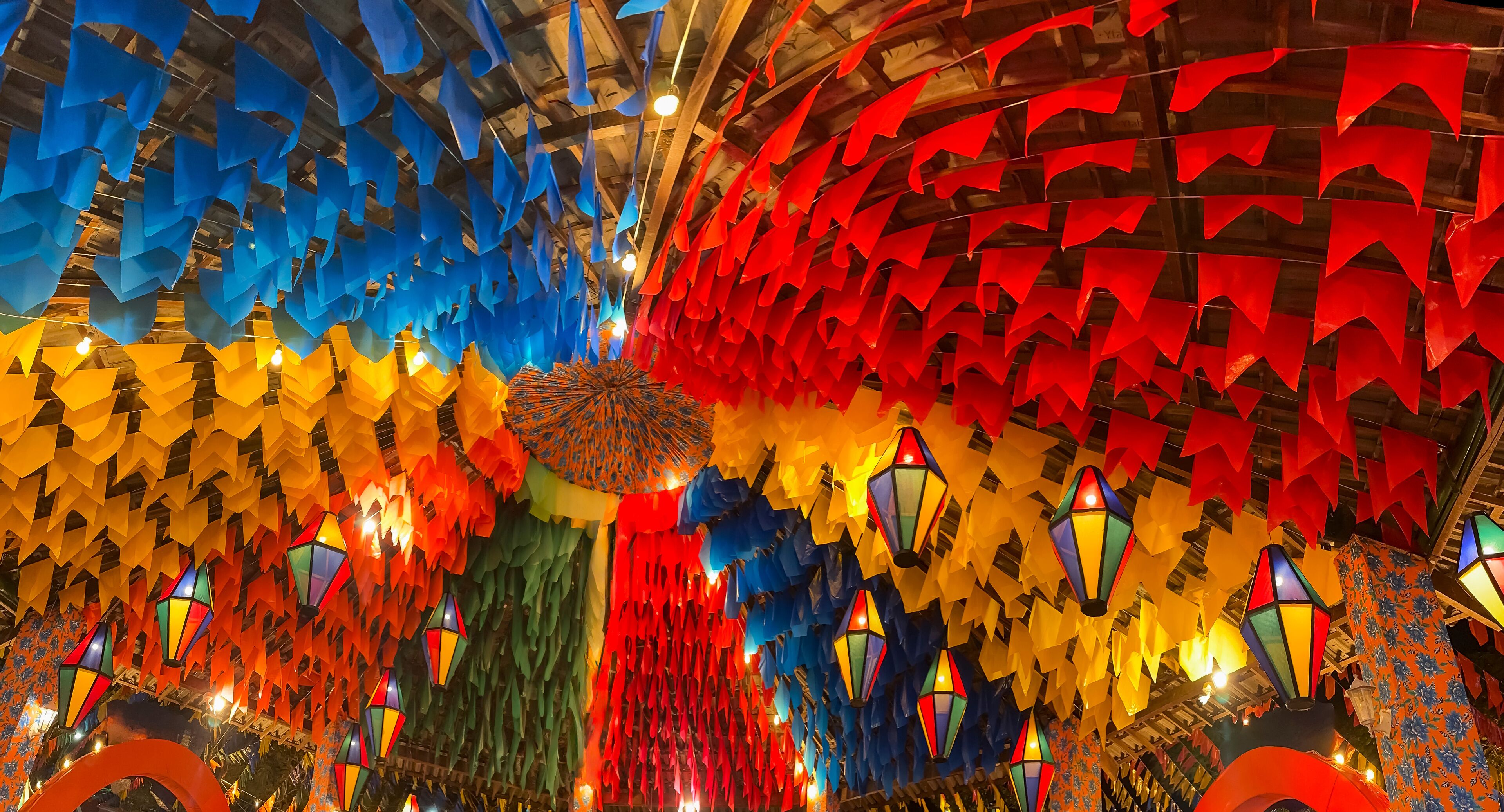 A ceiling adorned with colorful paper lanterns and geometric patterns.