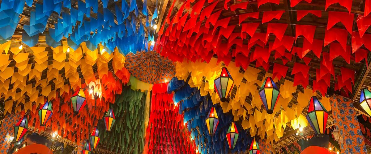 A ceiling adorned with colorful paper lanterns and geometric patterns.