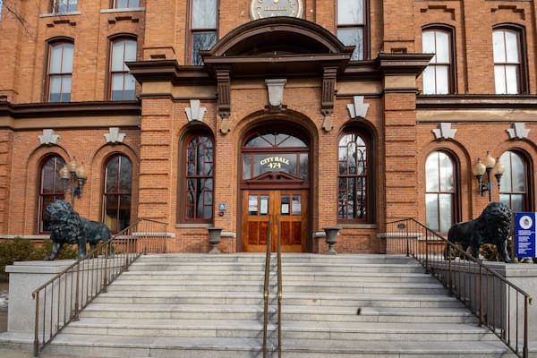 Saratoga Springs, NY - USA - Mar. 6, 2021: A closeup view of the entrance to the Saratoga Springs City Hall, an ornate three-story brick Italianate building built in 1871 by Cummings and Burt of Troy.