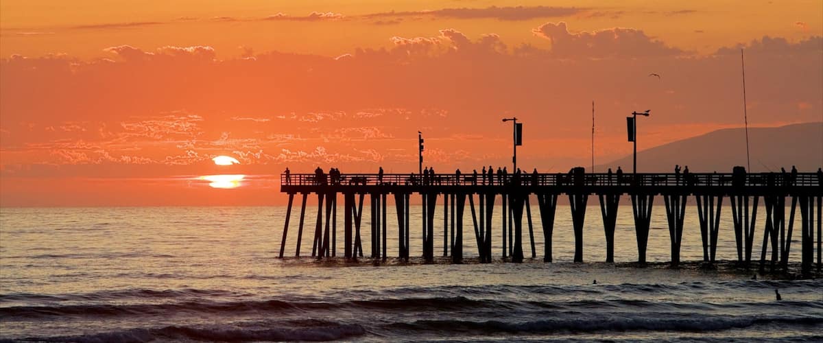 Pismo Beach which includes a sunset and general coastal views