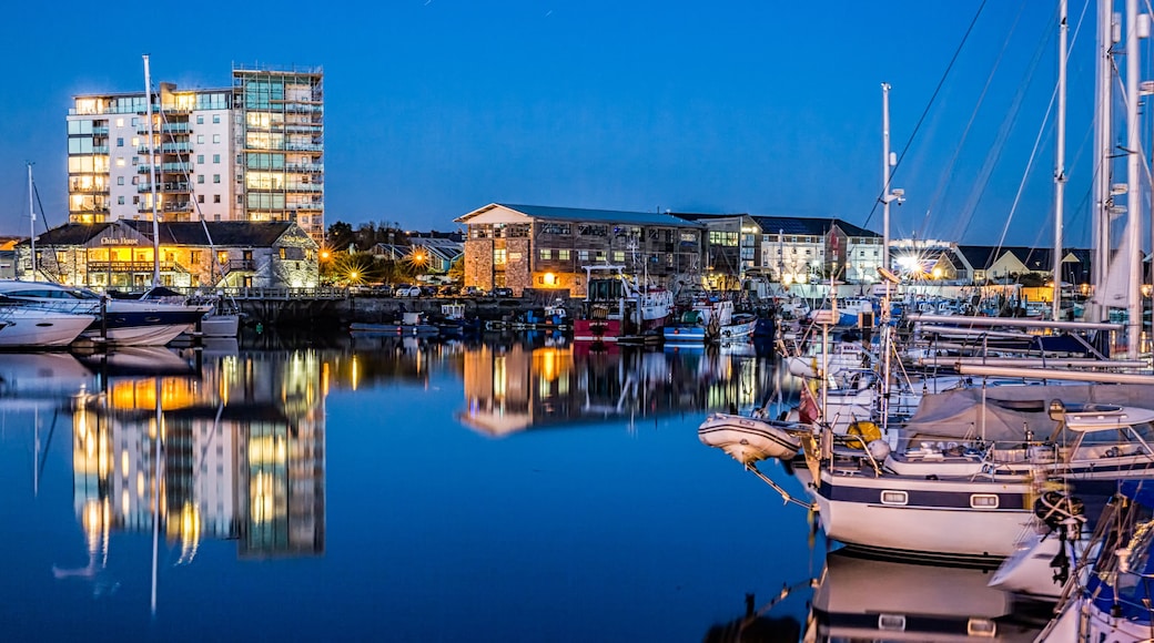 Yachts moored at the Plymouth Barbican Harbour at night