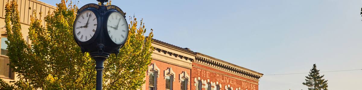 Golden Hour on Historic Plymouth Street with Clock and Autumn Trees