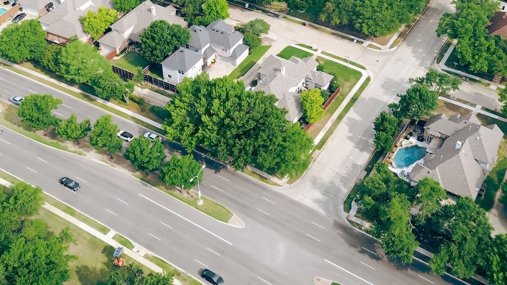 Panorama aerial view two story houses along West Plano Parkway with solar panel roof, modern inground pools, upscale neighborhood green space in rapid growing Plano, Texas, suburbs DFW metroplex