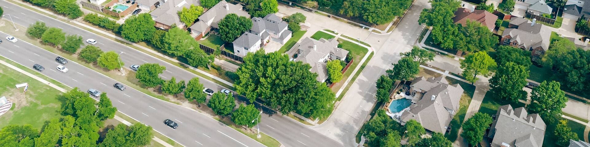 Panorama aerial view two story houses along West Plano Parkway with solar panel roof, modern inground pools, upscale neighborhood green space in rapid growing Plano, Texas, suburbs DFW metroplex
