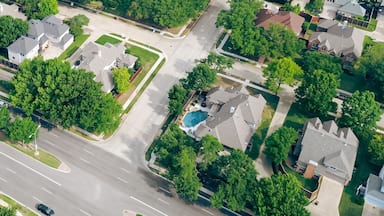 An aerial view of a suburban neighborhood with multiple roads, houses, and green spaces.