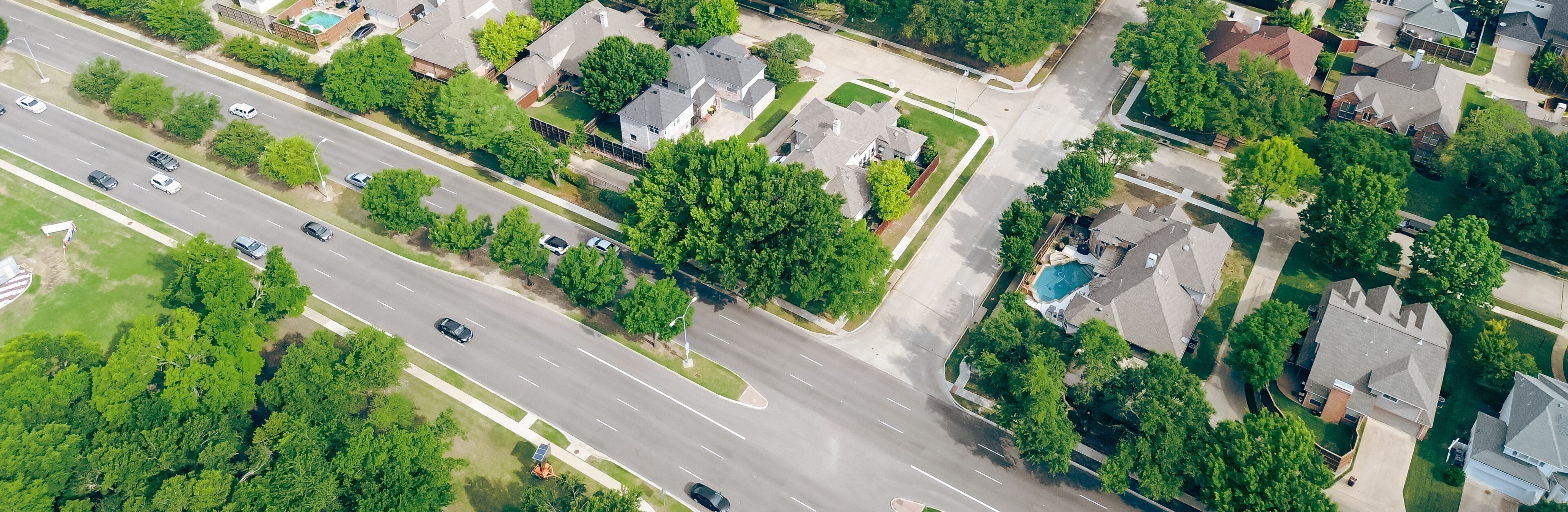Panorama aerial view two story houses along West Plano Parkway with solar panel roof, modern inground pools, upscale neighborhood green space in rapid growing Plano, Texas, suburbs DFW metroplex
