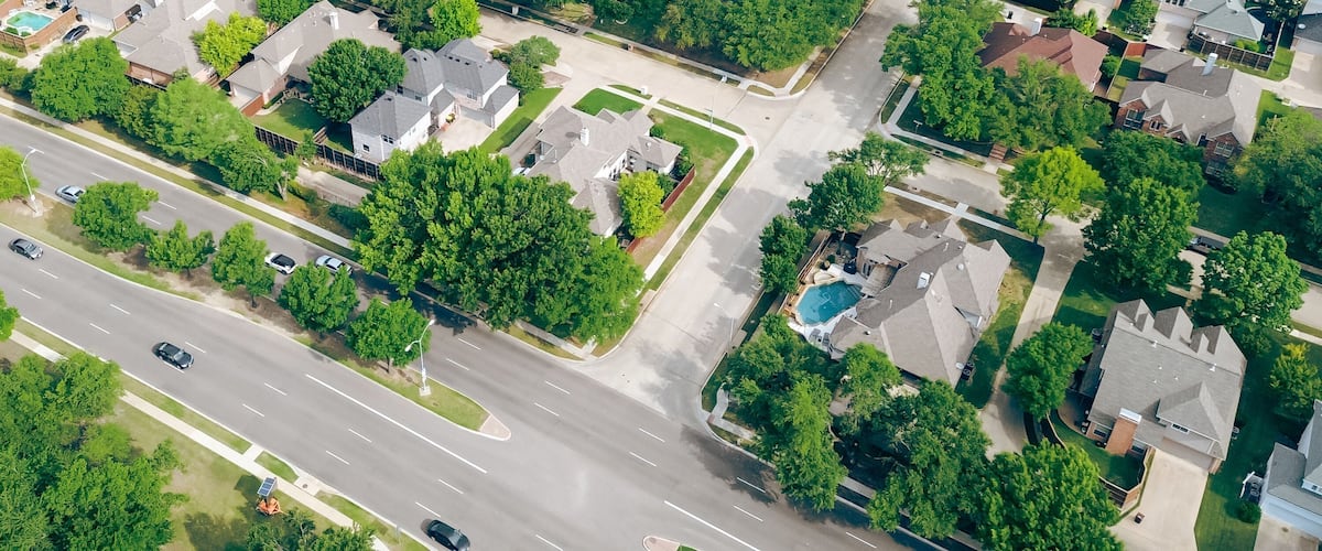 Panorama aerial view two story houses along West Plano Parkway with solar panel roof, modern inground pools, upscale neighborhood green space in rapid growing Plano, Texas, suburbs DFW metroplex