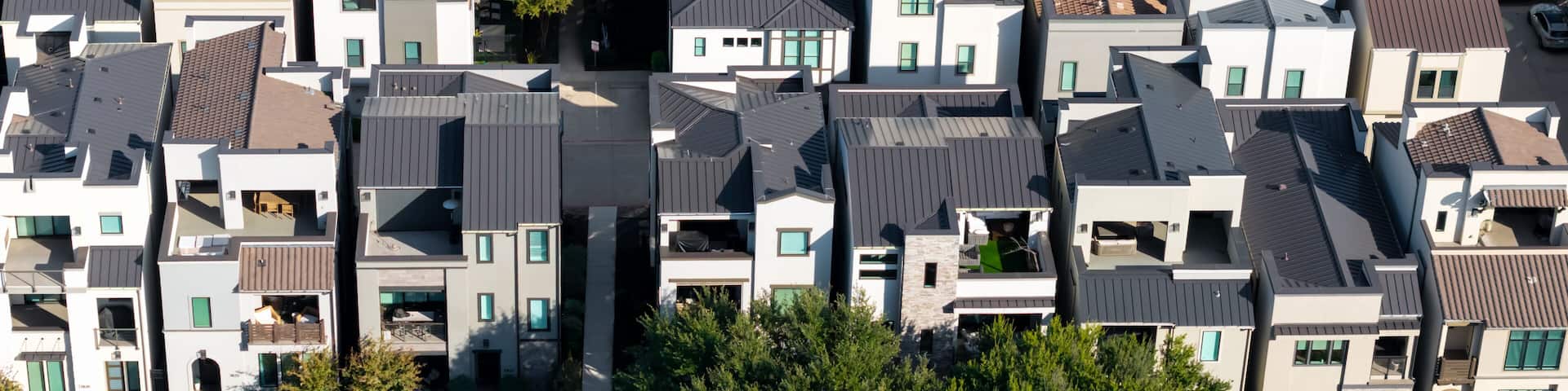 Modern suburban townhouses featuring unique architecture from above