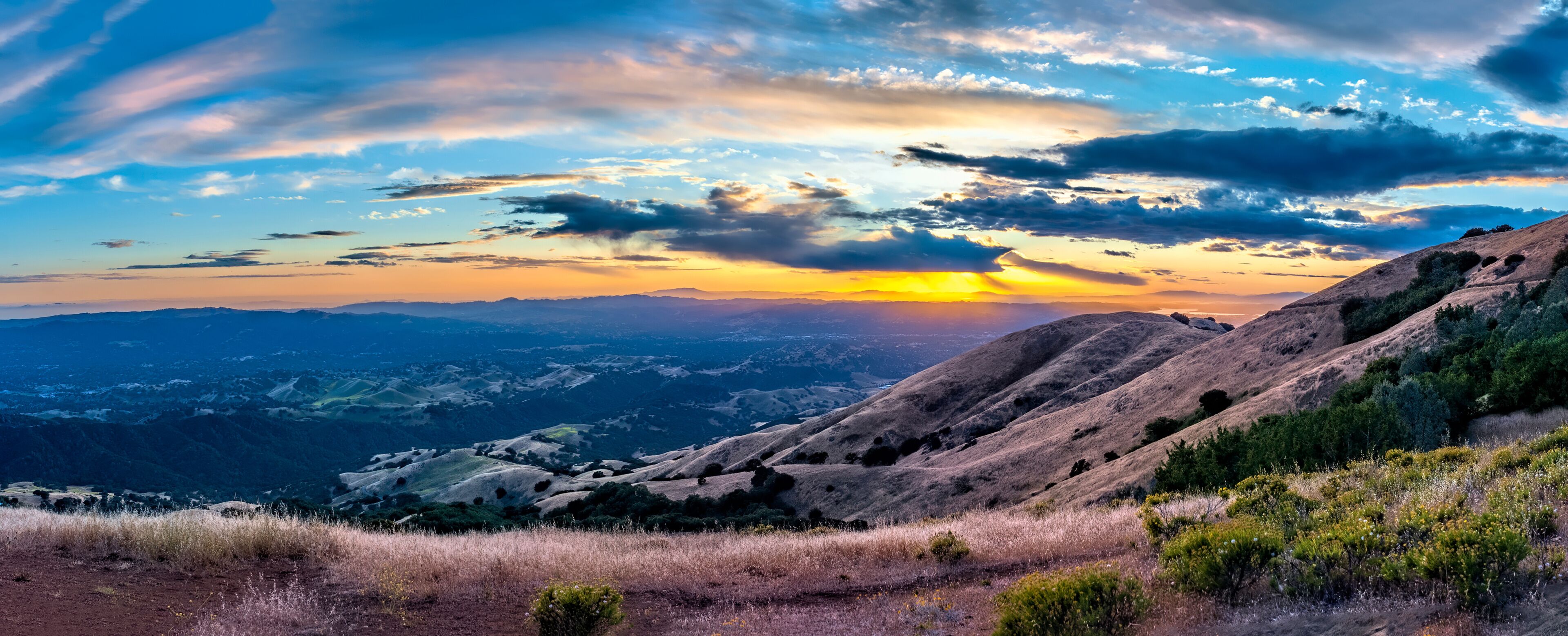 A mountainous landscape with a sunset.