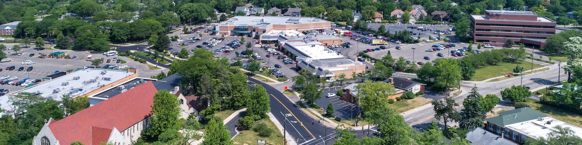 Aerial view of a business district with stores, a church and shopping center in downtown Northbrook, IL.