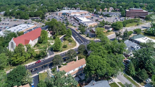 Aerial view of a business district with stores, a church and shopping center in downtown Northbrook, IL.