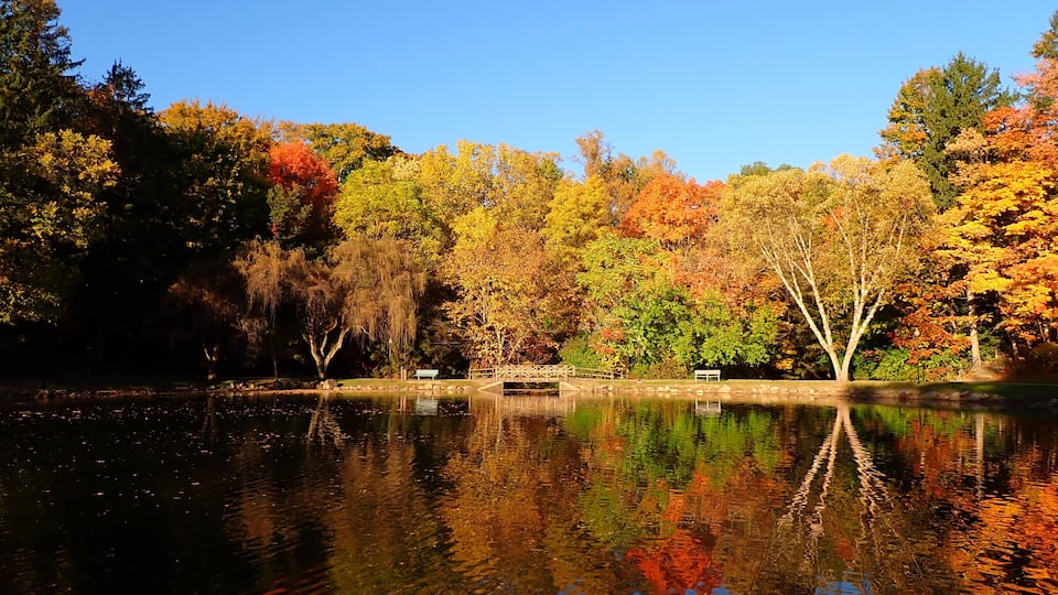 Silver Park, Alliance, Ohio looking across Lake Kidwell at the foot bridge on a beautiful fall afternoon in October with a clear blue sky
