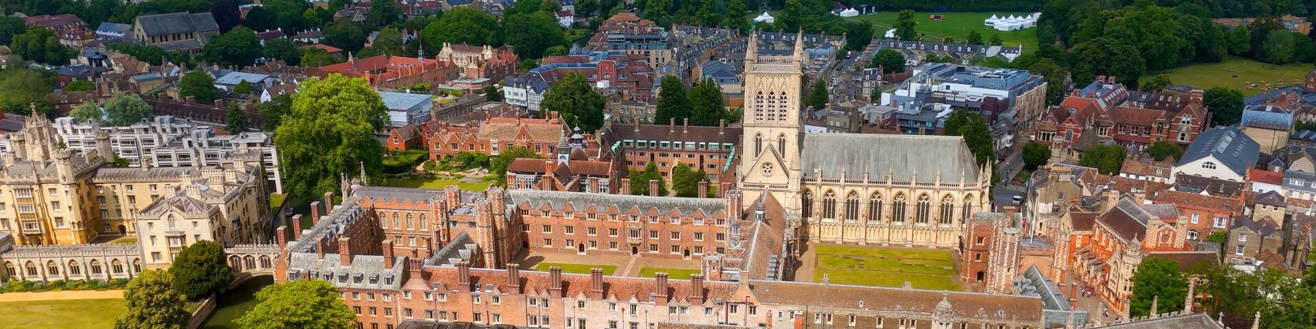 Aerial view of Cambridge University campus with surrounding city on a sunny summer day