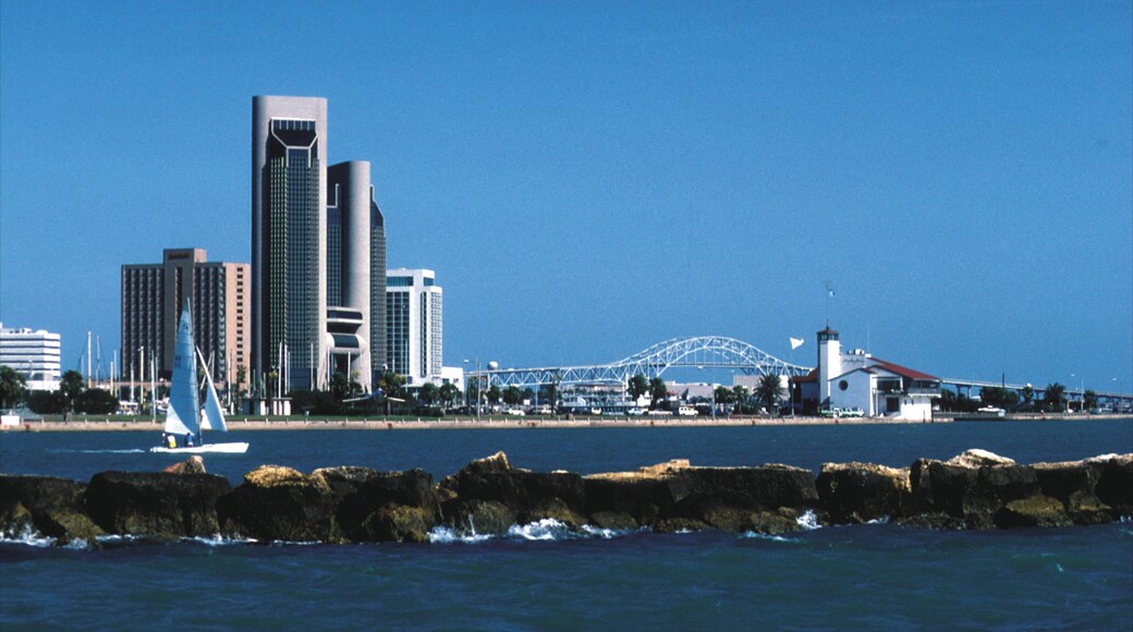 Vibrant waterfront view of Corpus Christi showcasing urban skyline and sailing activity on a clear day