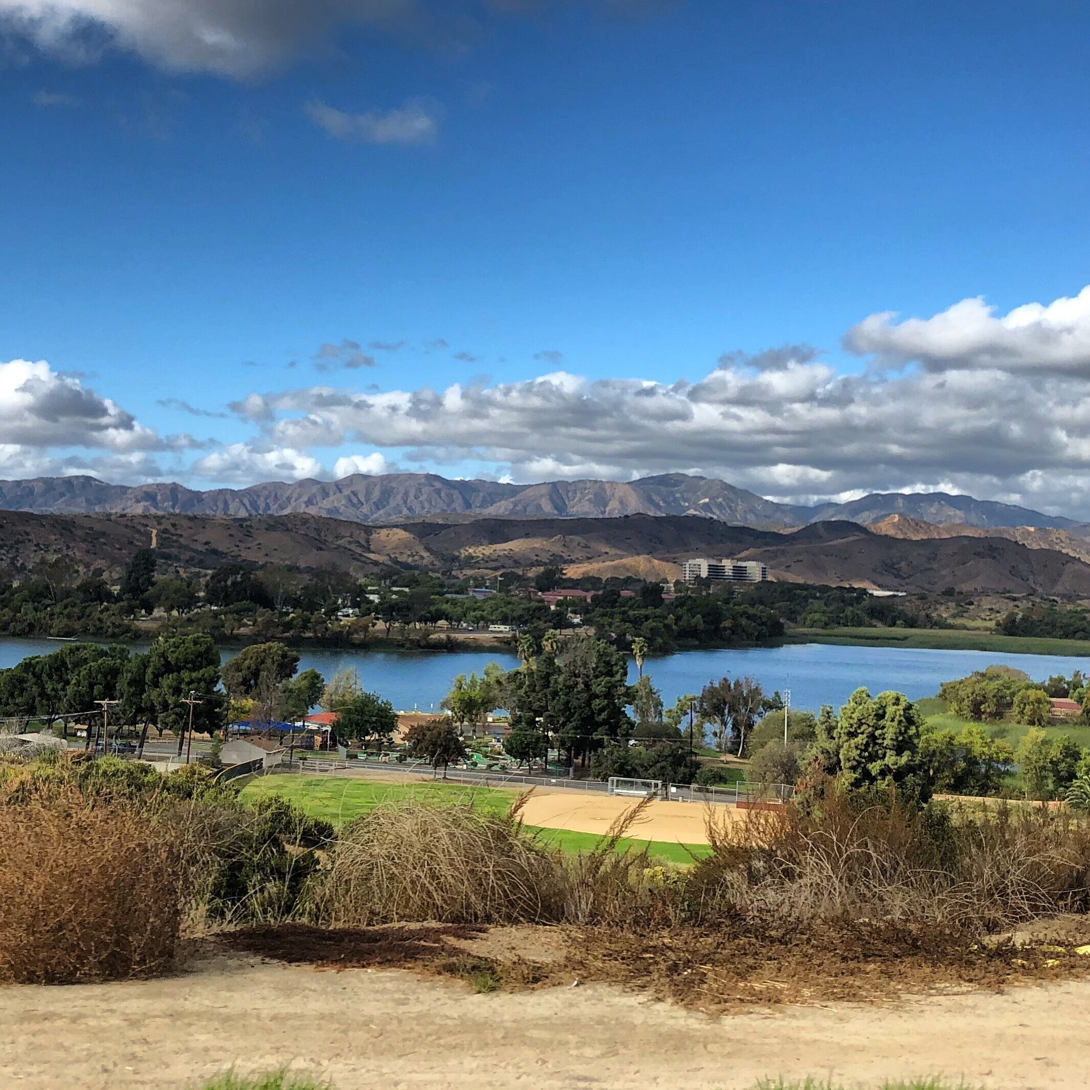 A lake surrounded by mountains and a small town.