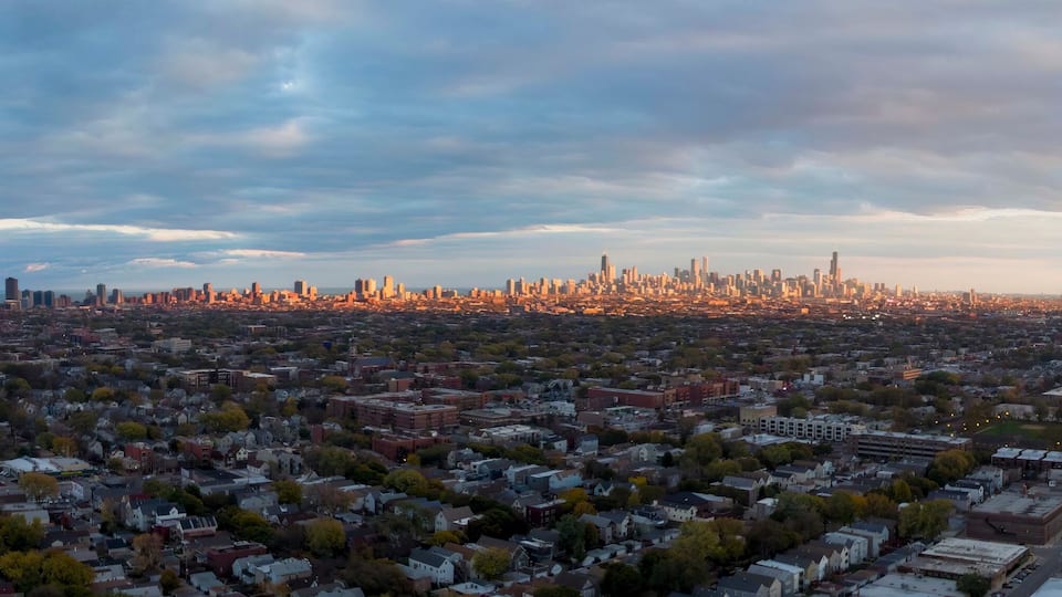 A cityscape with a dense urban area and a distant skyline.
