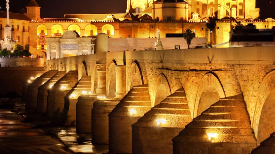 By June Córdoba is unbearably hot in the daytime but the city comes alive at night. If you cross the puente Romano you'll get a superb view of the cathedral and it's all lit up at night