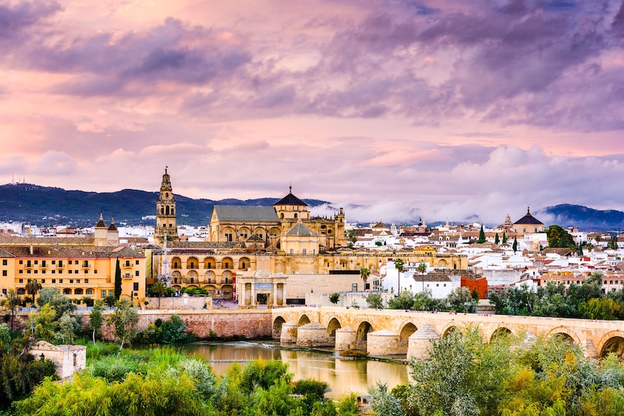 Cordoba, Spain at the Roman Bridge and Mosque-Cathedral on the Guadalquivir River.