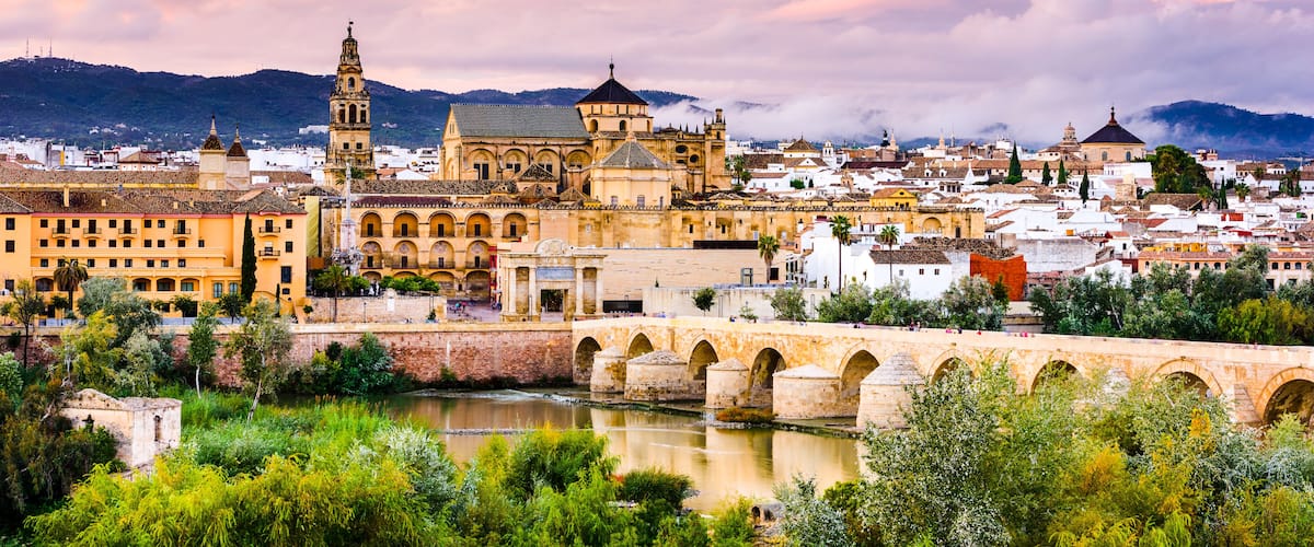 Cordoba, Spain at the Roman Bridge and Mosque-Cathedral on the Guadalquivir River.