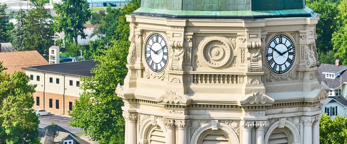 Close up aerial of Columbia City courthouse clock tower with dome