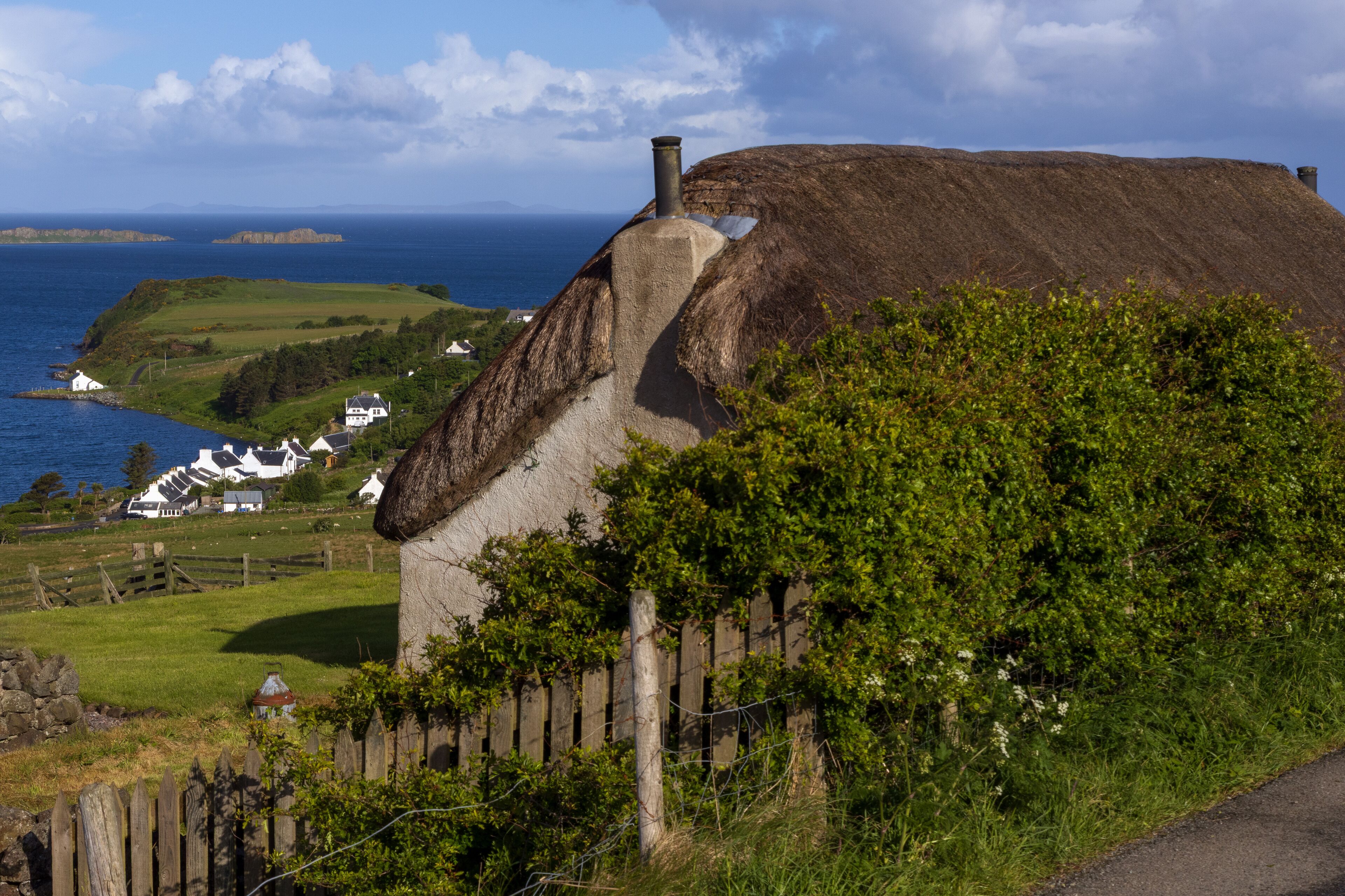 thatched cottage, crofter's house at the Waternish peninsula with view to the fishing village of Stein, Isle of Skye, Scotland