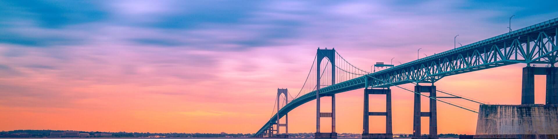 Dramatic beautiful sunset landscape over Claiborne Pell Newport Bridge, a modern tolled suspension bridge across Narragansett Bay, connecting Newport Jamestown, Rhode Island