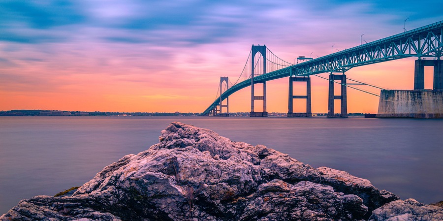 Dramatic beautiful sunset landscape over Claiborne Pell Newport Bridge, a modern tolled suspension bridge across Narragansett Bay, connecting Newport Jamestown, Rhode Island