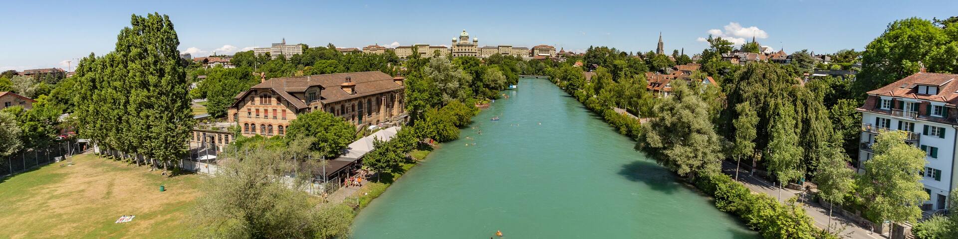 Bern, Switzerland - July 30, 2019: Aerial view of Aar from the Monbijoubrucke Bridge. Brige over the Aare river. Bern Switzerland. The Parliament Building on the background. Super wide angle panorama
