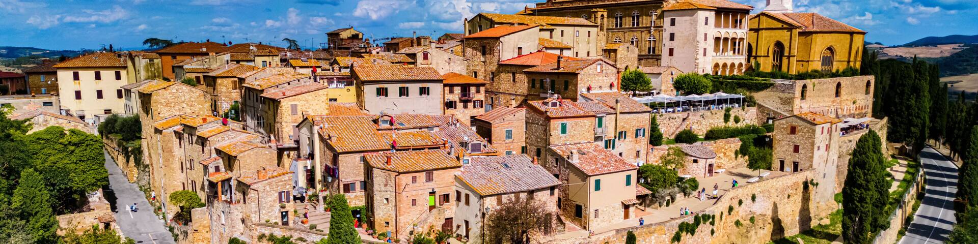 A historic town with stone buildings, a prominent church, and a winding road.